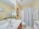 Well-lit bathroom with vanity, mirror, and shower with patterned curtain at 5076 Timber Falls Dr, Indian Land, SC 29707
