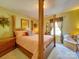 Bedroom featuring a four-poster bed, side tables, and window with decorative curtains at 5076 Timber Falls Dr, Indian Land, SC 29707
