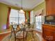 Cozy dining area filled with natural light has wrought iron table set and a door to outdoor seating at 5076 Timber Falls Dr, Indian Land, SC 29707