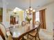 Formal dining room featuring elegant chandelier, hardwood floors, and natural light at 5076 Timber Falls Dr, Indian Land, SC 29707
