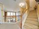 Bright foyer with wood railing, carpeted stairs, and natural light at 5076 Timber Falls Dr, Indian Land, SC 29707