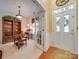 Inviting foyer showcasing a front door, hardwood floors, and an adjacent office space at 5076 Timber Falls Dr, Indian Land, SC 29707