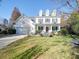 Charming two-story home with a well-manicured lawn, seating, and a welcoming front porch at 5076 Timber Falls Dr, Indian Land, SC 29707