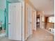 Hallway with three white doors, showing access to other rooms of the home at 5076 Timber Falls Dr, Indian Land, SC 29707