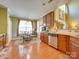 Eat-in kitchen features wood cabinets, stainless steel appliances, and an adjacent dining area with large windows at 5076 Timber Falls Dr, Indian Land, SC 29707