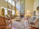 Elegant living room featuring high ceilings, large windows, a fireplace, and luxury furniture at 5076 Timber Falls Dr, Indian Land, SC 29707
