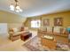 Comfortable living room with neutral tones, sofas, rug, and ample natural light at 5076 Timber Falls Dr, Indian Land, SC 29707