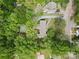 Aerial view of home nestled among green trees showing its roofline and driveway at 528 W Park Dr, Monroe, NC 28112