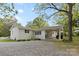 View of a backyard with white brick home, carport and gravel area at 528 W Park Dr, Monroe, NC 28112