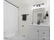 Modern bathroom with a white vanity, framed mirror, and shower with a white curtain at 528 W Park Dr, Monroe, NC 28112