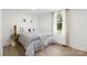Cozy bedroom with natural light, hardwood floors, and minimalist decor at 528 W Park Dr, Monroe, NC 28112