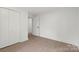 Spacious bedroom featuring double closet doors and wood-look flooring, providing ample storage at 528 W Park Dr, Monroe, NC 28112