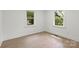Sunlit bedroom featuring bright windows, neutral walls, and wood-look flooring at 528 W Park Dr, Monroe, NC 28112
