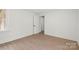 Light bedroom showcasing neutral walls, wood-look flooring, and a bright, airy feel at 528 W Park Dr, Monroe, NC 28112