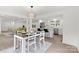 Bright, open dining area with stylish lighting, adjacent to a modern kitchen with stainless steel appliances and center island at 528 W Park Dr, Monroe, NC 28112