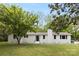 Charming white brick home featuring a well-manicured lawn and mature trees in a serene setting at 528 W Park Dr, Monroe, NC 28112