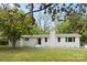 Charming white brick home featuring a well-manicured lawn and mature trees in a serene setting at 528 W Park Dr, Monroe, NC 28112