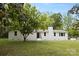 Charming white brick home featuring a well-manicured lawn and mature trees in a serene setting at 528 W Park Dr, Monroe, NC 28112