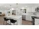 Modern kitchen features white cabinets, stainless steel appliances, a center island, and view of the adjacent living area at 528 W Park Dr, Monroe, NC 28112