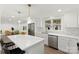 Bright kitchen with white cabinets, stainless steel appliances, a center island, and view of the adjacent living area at 528 W Park Dr, Monroe, NC 28112