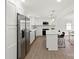 Stylish kitchen features stainless steel appliances, white cabinetry, a center island, and an open design to the dining area at 528 W Park Dr, Monroe, NC 28112