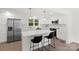 Bright kitchen with white cabinets, stainless steel appliances, a center island with seating, and updated fixtures at 528 W Park Dr, Monroe, NC 28112