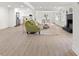 Bright, open-concept living area with modern flooring, fireplace, and seamless flow to the kitchen and dining space at 528 W Park Dr, Monroe, NC 28112