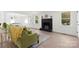 Open-concept living area featuring modern flooring, fireplace, and view of the kitchen and dining space at 528 W Park Dr, Monroe, NC 28112