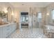 Spa-like bathroom featuring a glass enclosed shower, soaking tub, and beautiful wallpaper at 611 Wisteria Vines Trl, Fort Mill, SC 29708