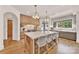 Spacious kitchen featuring a large island, pendant lighting, and modern appliances at 611 Wisteria Vines Trl, Fort Mill, SC 29708