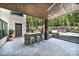 Outdoor kitchen and bar with a built-in grill, seating, and a beautiful green setting at 611 Wisteria Vines Trl, Fort Mill, SC 29708
