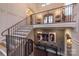 Grand staircase with iron railings, hardwood treads, and a view of the home's entryway at 611 Wisteria Vines Trl, Fort Mill, SC 29708