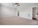 Spacious, carpeted room featuring neutral walls, and ceiling fan offering a versatile space at 6220 Raven Rock Dr, Denver, NC 28037