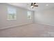 Bright, spacious bedroom with neutral carpeting and two windows offering plenty of natural light at 6220 Raven Rock Dr, Denver, NC 28037