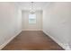 Empty dining room featuring hardwood floors and natural light at 6220 Raven Rock Dr, Denver, NC 28037