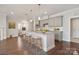 Modern kitchen features a large island with bar seating and stainless steel appliances at 6220 Raven Rock Dr, Denver, NC 28037
