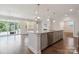Kitchen island view into living room featuring gas fireplace and outdoor patio access at 6220 Raven Rock Dr, Denver, NC 28037