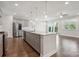 Stylish island has pendant lighting, stainless dishwasher, sink, and bar seating at 6220 Raven Rock Dr, Denver, NC 28037