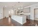 Bright kitchen with a large central island, pendant lighting, and granite countertops at 6220 Raven Rock Dr, Denver, NC 28037
