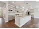 Bright kitchen features granite countertops, stainless appliances, gray cabinets, and hardwood floors at 6220 Raven Rock Dr, Denver, NC 28037