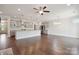 Open-concept living room with hardwood floors, leading into a modern kitchen with bar seating at 6220 Raven Rock Dr, Denver, NC 28037