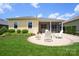 Charming patio with brick flooring, bright yellow siding, and white Adirondack chairs surrounded by green grass at 6220 Raven Rock Dr, Denver, NC 28037