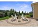 Outdoor entertaining space with round patio and four adirondack chairs surrounding fire pit at 6220 Raven Rock Dr, Denver, NC 28037