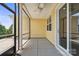 View of yellow, screened-in back porch with ceiling fan and tiled flooring at 6220 Raven Rock Dr, Denver, NC 28037