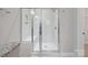 Modern bathroom featuring a frameless glass shower with marble tile, a built-in bench, and a rainfall shower head at 6220 Raven Rock Dr, Denver, NC 28037