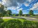 Scenic street view showcases a peaceful neighborhood with lush greenery, mature trees, and clear blue skies at 6220 Raven Rock Dr, Denver, NC 28037