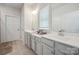 Bathroom with double sink vanity, neutral color palette, and lots of light at 6242 Ashton Park Dr, Denver, NC 28037