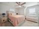 Well-lit bedroom featuring a crib, a bed and two bedside tables at 6242 Ashton Park Dr, Denver, NC 28037