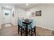 Dining area features a table with seating for four; a doorway and clock are visible at 6242 Ashton Park Dr, Denver, NC 28037