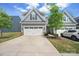 Charming two-story home boasts a three-car garage, and manicured landscaping at 6242 Ashton Park Dr, Denver, NC 28037